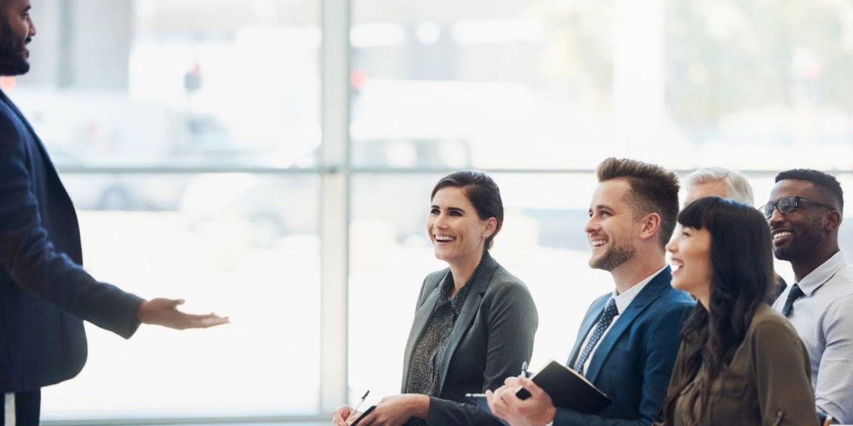 Young, diverse workforce sitting through a conference