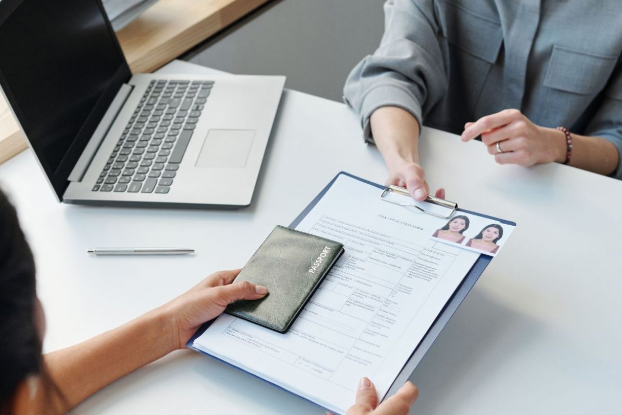 Woman submitting a visa application at consular