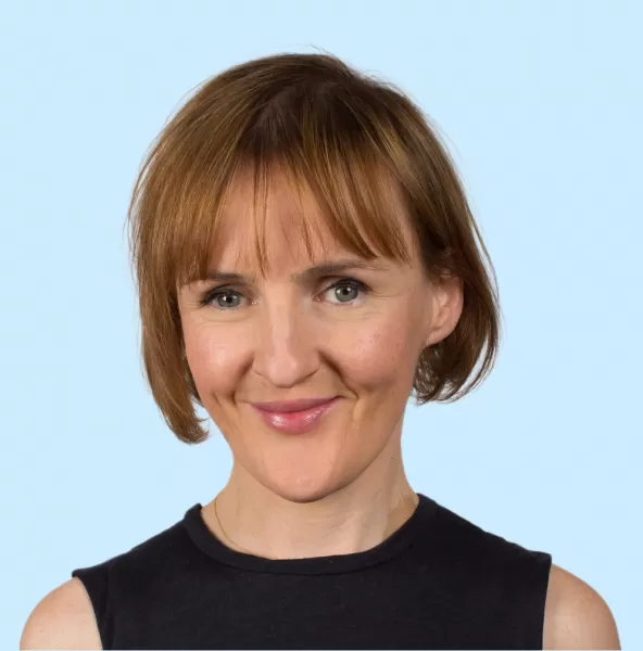 Louise Reposo Headshot with Blue Background